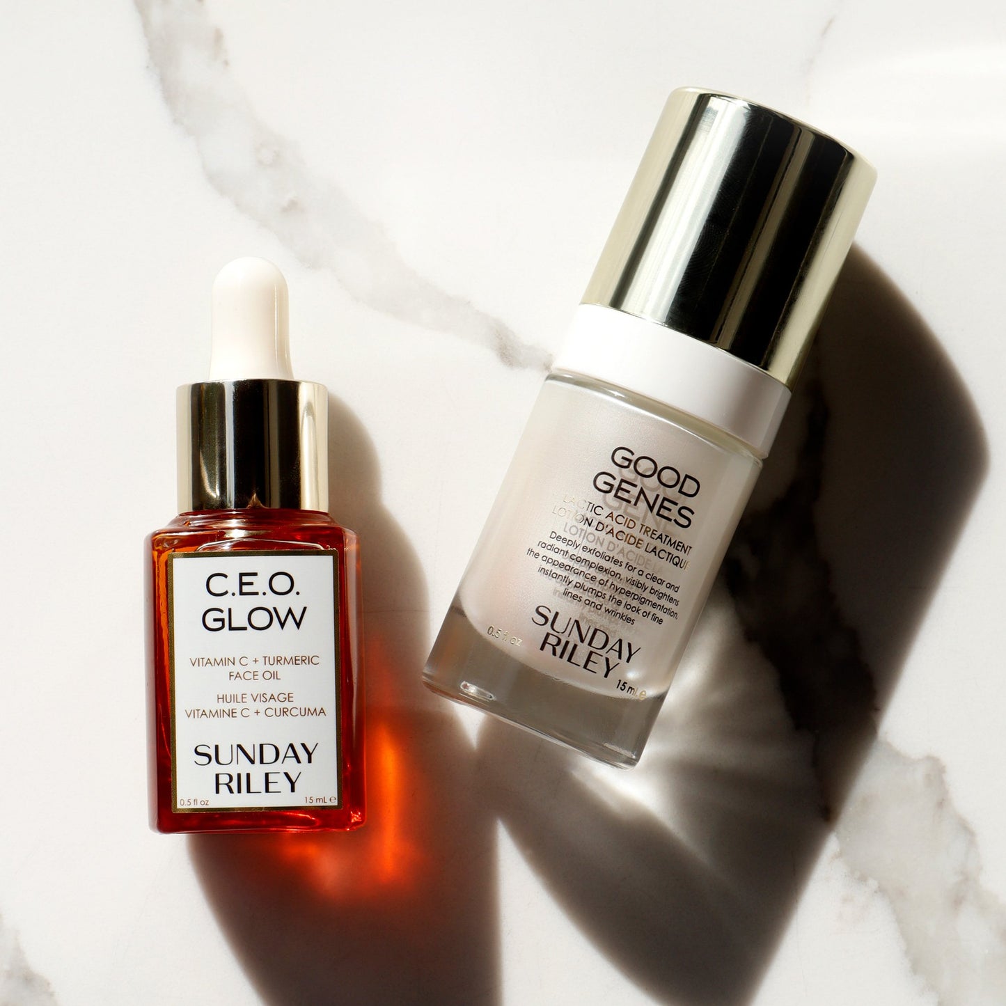 CEO Glow and Good Genes bottles lying down on marble
