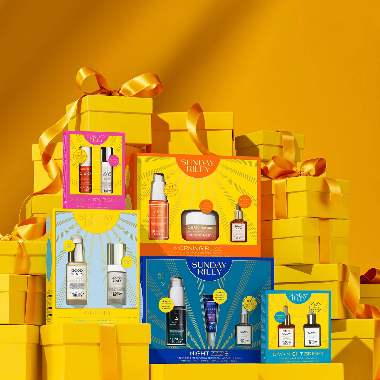 DOUBLE YOUR GLOW, MORNING BUZZ, WIN-WIN, NIGHT ZZZ'S, and DAY + NIGHT BRIGHT packs on top of gift box props on display