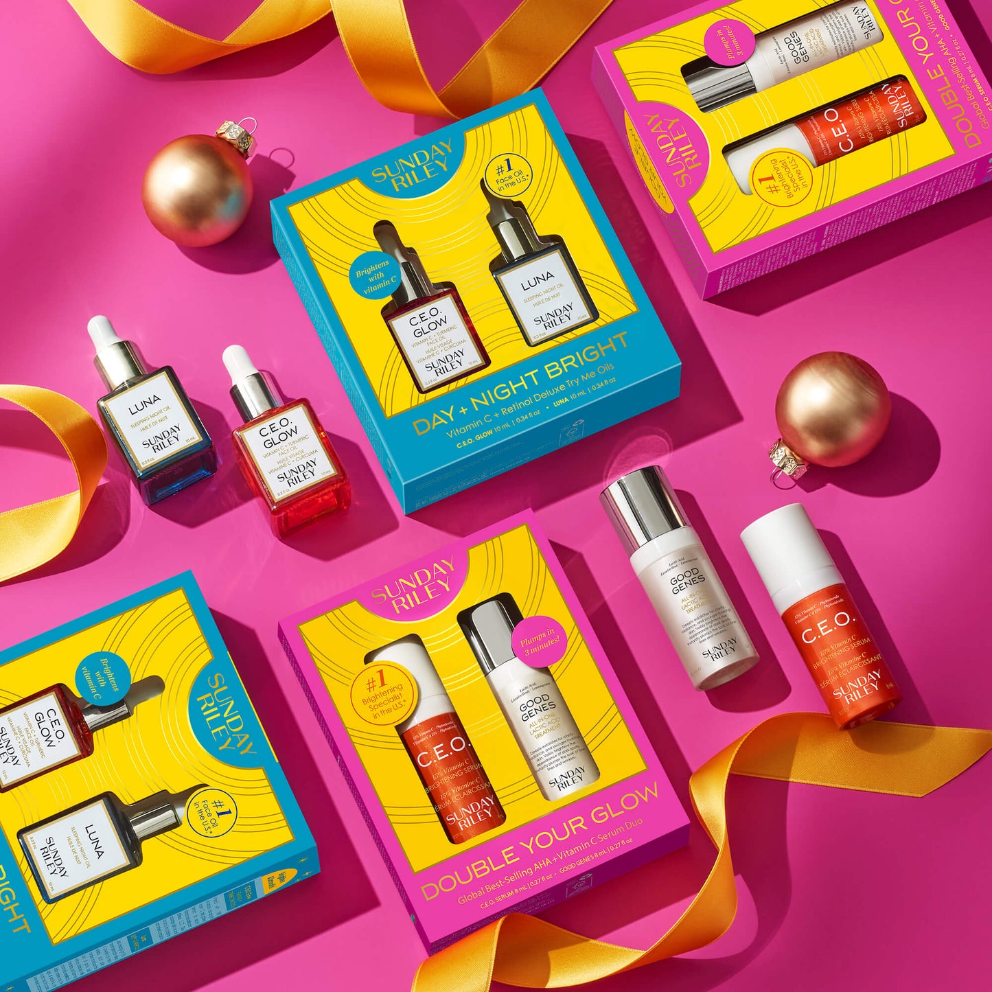Double Your Glow - Global Best Selling AHA + Vitamin C Serum Duo pack with the product bottles laying next to it, and DAY + NIGHT BRIGHT Vitamin C + Retinol Deluxe Try Me Oils pack with bottles laying next to it - on top of a pink background with yellow ribbons and ornaments for decoration